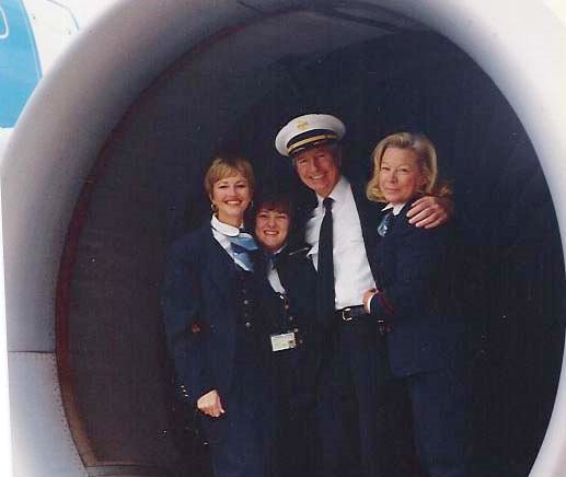 1991, October, flight attendants, left to right, Judy Skartvedt, Jan Pope, unnamed pilot, and Doris Burke pose in the engine of a Pan Am Airbus A310 on the ramp in Rome Italy.
